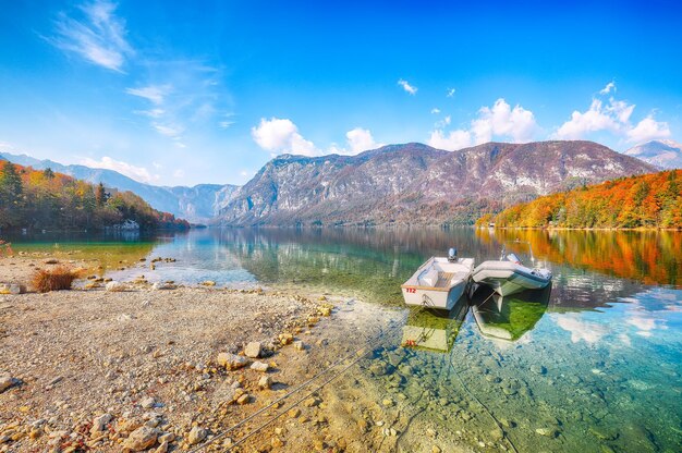 Fabulous view of bohinj lake with boats during autumn popular tourist destination location municipality of bohinj upper carniola region triglav national park slovenia europe