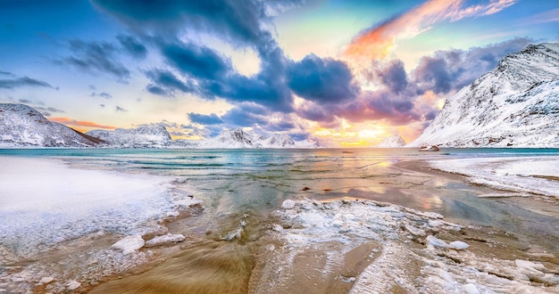 Fabulous winter scenery with Haukland beach during sunset and snowy mountain peaks near Leknes