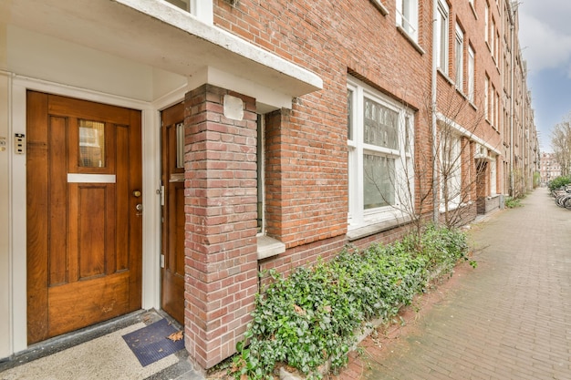 The facade of a brick building with wooden door