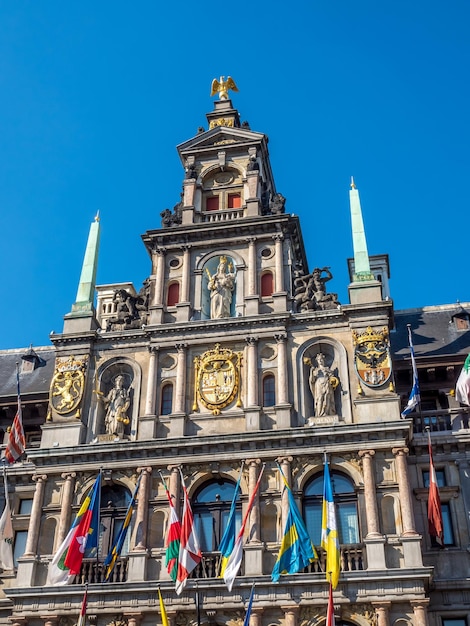 Facade of City Hall on the Great Market Square of Antwerp Belgium under blue sky in sunny day