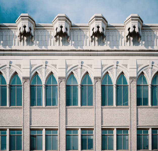 Facade of classic building with windows and ornamental details Photo