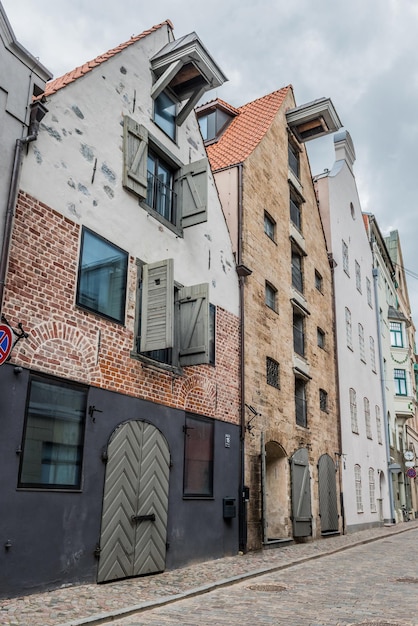 Facade of an old industrial building an old warehouse with large windows and gates. Street of Riga, Latvia.