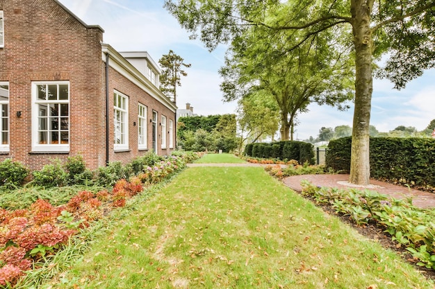 The facade of a one-story brick house with a green fresh lawn