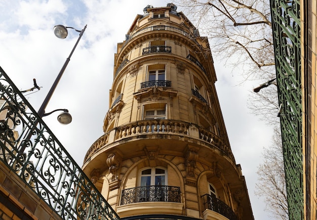 The facade of traditional french house with typical balconies and windows paris france