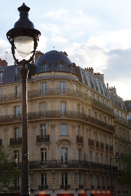 The facade of traditional french house with typical balconies and windows paris france