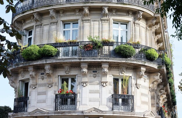 The facade of traditional French house with typical balconies and windows Paris