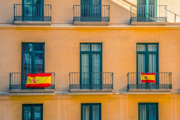 Facade with windows and spanish flags.