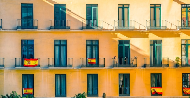 Facade with windows and spanish flags.