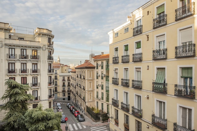 Facades of old urban residential buildings in the historic center of Madrid on streets with cobblestone walkways