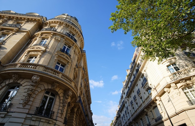 The facades of traditional French houses with typical balconies and windows Paris