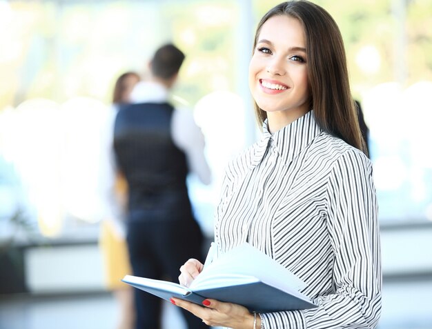 Face of beautiful woman on the background of business people