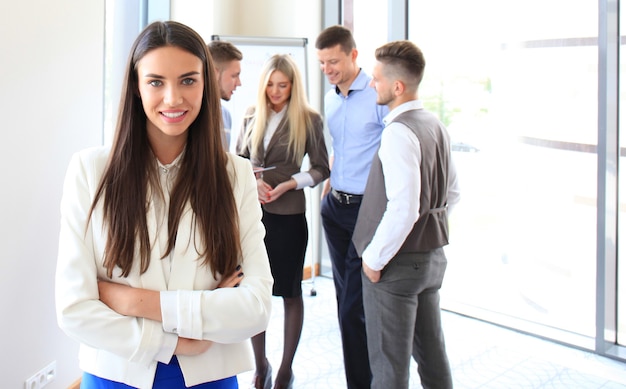 Face of beautiful woman on the background of business people