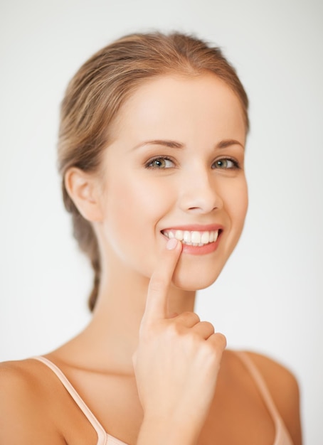 face of beautiful woman showing her teeth