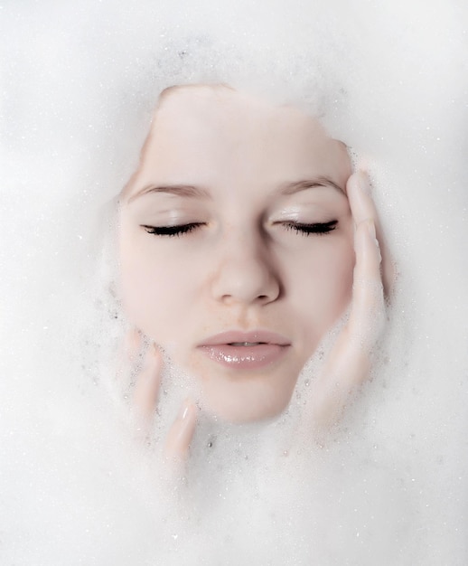 Face of a beautiful woman in white foam