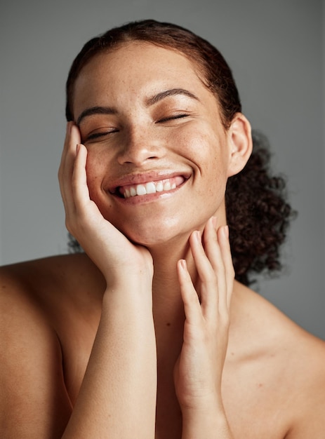 face beauty and skincare with a model black woman in studio on a gray background to promote natural care facial wellness and makeup with an attractive young female happy with her skin product