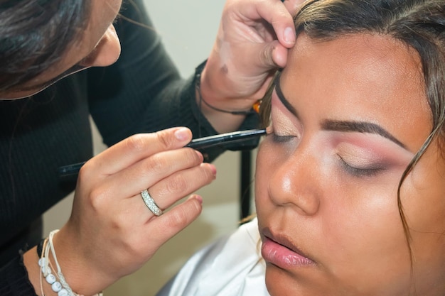 Face of brunette woman being made up