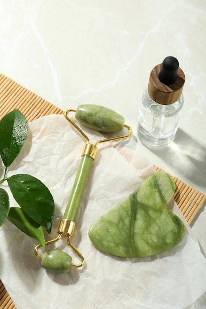 Face care concept with gua sha face roller and cosmetic