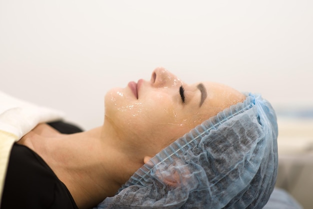 Face cleaning in a beauty salon closeup of a woman's face