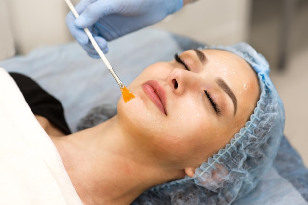 Face cleaning in a beauty salon closeup of a woman's face