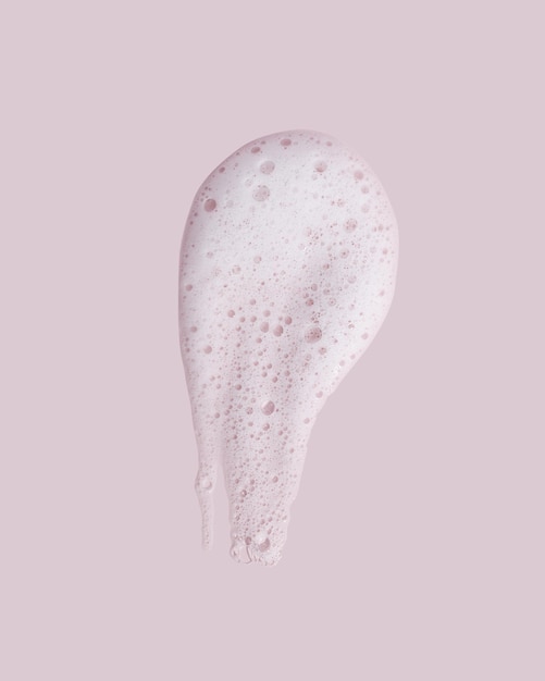 Face cleansing mousse texture on pink background