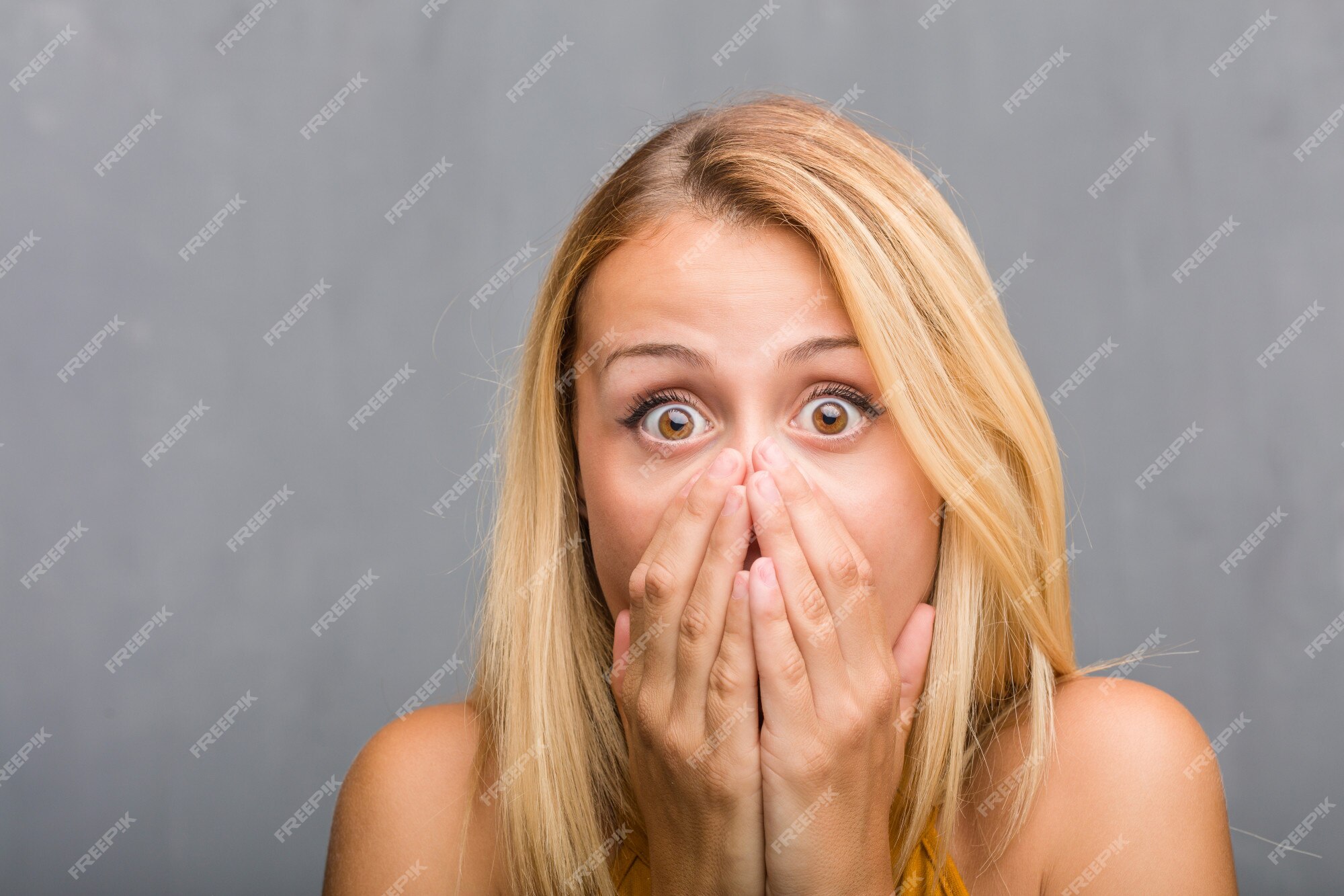 Close up of a young scared and frightened woman, covering herself