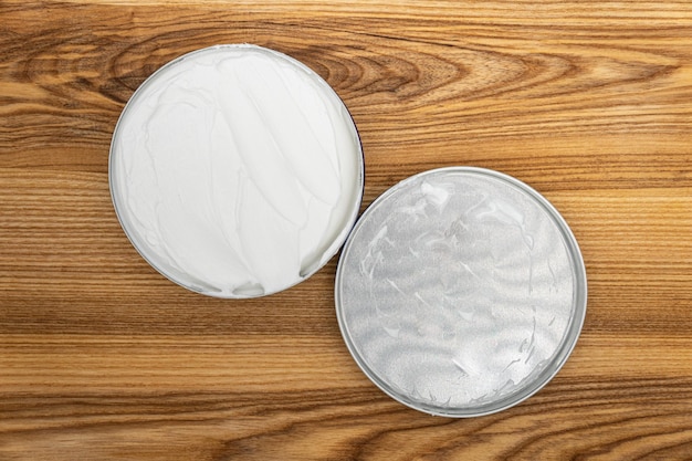 Face cream isolated on a wooden background Jar with moisturizing cosmetic product