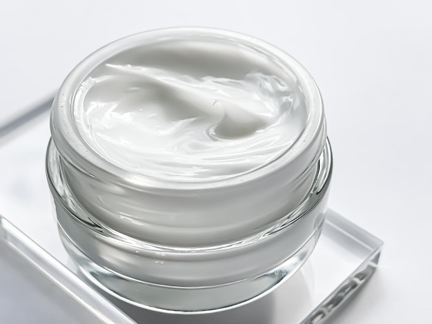 Face cream moisturiser jar and product sample on glass beauty and skincare cosmetic science