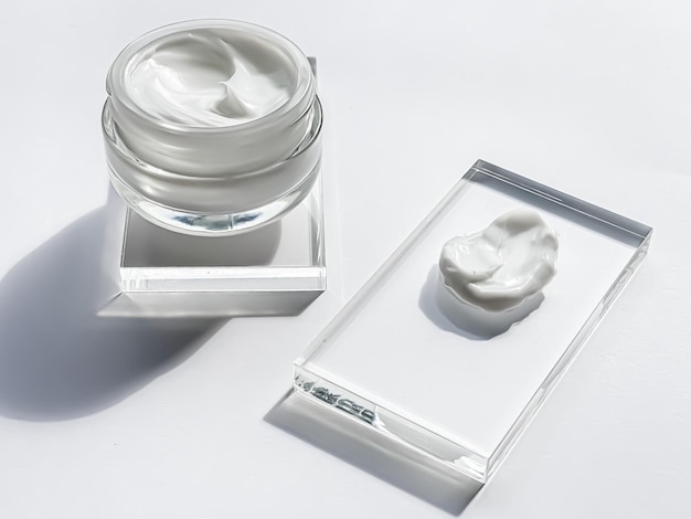 Face cream moisturiser jar and product sample on glass beauty and skincare cosmetic science