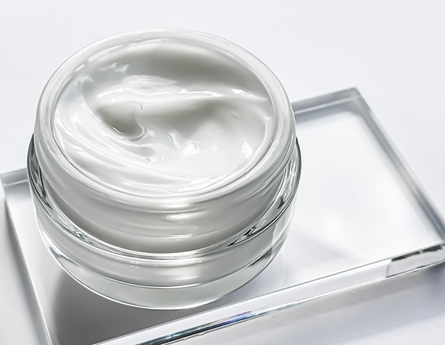 Face cream moisturiser jar and product sample on glass beauty and skincare cosmetic science