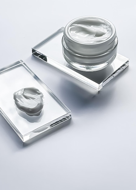 Face cream moisturiser jar and product sample on glass beauty and skincare cosmetic science