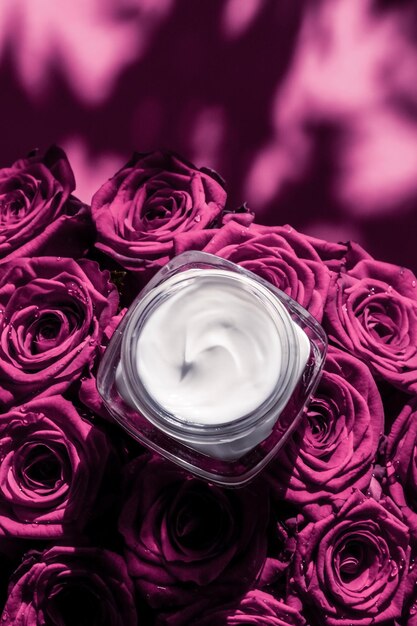 Face cream skin moisturizer on pink roses flowers luxury skincare cosmetic product on floral background as beauty brand holiday flatlay design