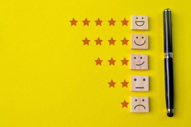 Face emotions with star ratings isolated on yellow background