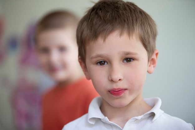 The face of a fiveyearold boy with brown eyes The little boy looks into the camera