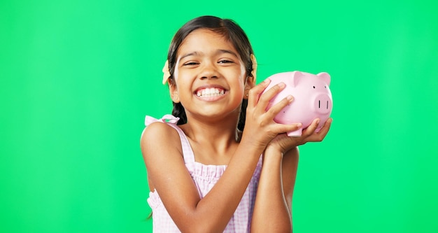 Photo face green screen and girl child with piggy bank in studio happy and excited for savings on mockup background portrait money and box by mexican kid smiling for cash growth or future planning