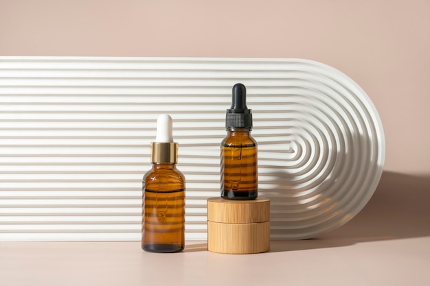 A face or hair serum or essential oil in a brown dropper bottle standing on a wooden podium Product marketing cosmetics mockup