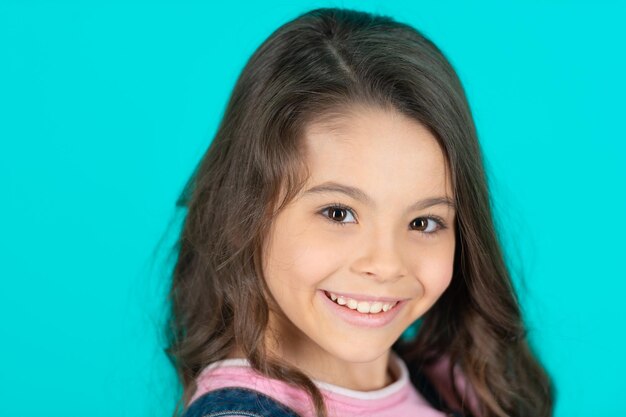 Face of happy teen girl isolated on blue face of teen girl in studio face of teen girl