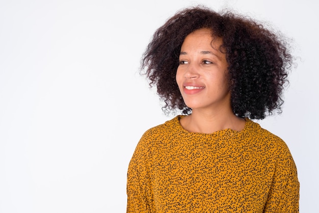 Face of happy young beautiful African woman thinking