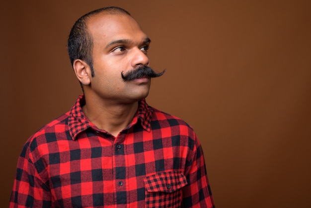Face of Indian hipster man with mustache
