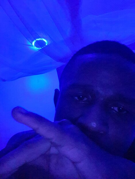 Face of a man in the blue light