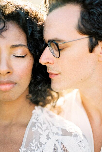 Face of a man with glasses next to the face of a woman Closeup