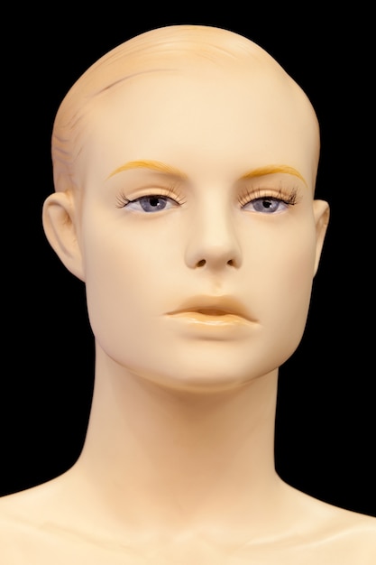 Face of a mannequin isolated on black background