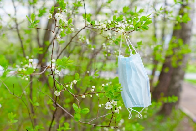 A face mask on a branch of a tree