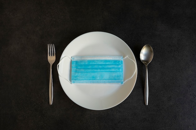 Face mask on a plate on a concrete table