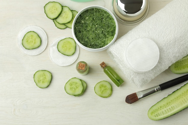Face mask with cucumber. Cosmetics with cucumber extract on a white wooden table. spa. beauty. top view