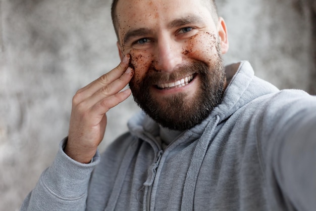 face masks chocolate cream and clay masks Photo of man with perfect skin Grooming himself