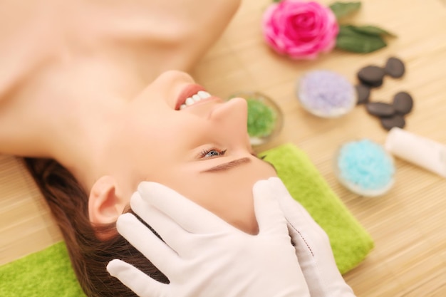 Face Massage. Close-up of a Young Woman Getting Spa Treatment.