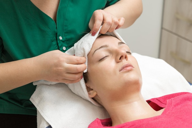 Face massage. Young woman getting spa massage treatment at beauty spa salon.