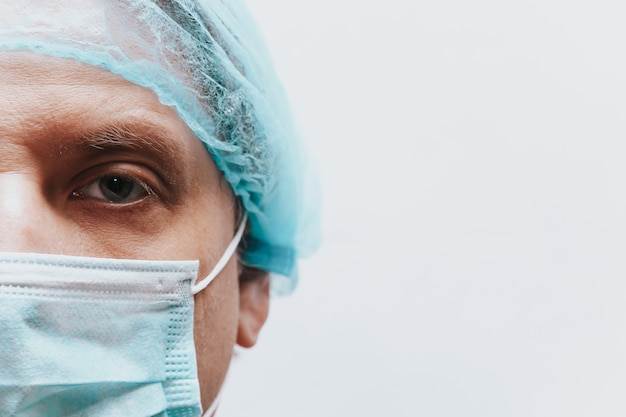 Face in a medical mask close up