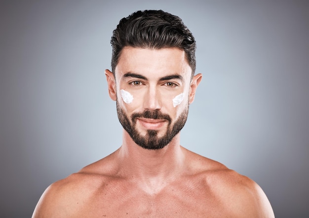 Face portrait skincare cream and man in studio isolated on a gray background for wellness Cosmetics dermatology and young male model with lotion creme or moisturizer product for facial health