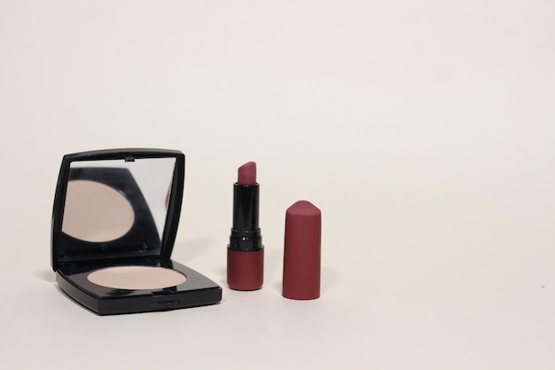 Face powder with mirror and lipstick makeup background